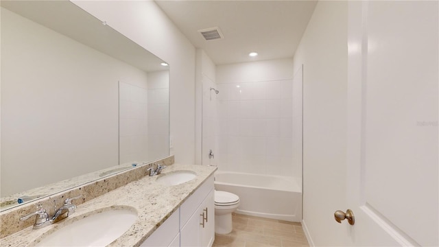 full bathroom featuring vanity, tiled shower / bath combo, and toilet