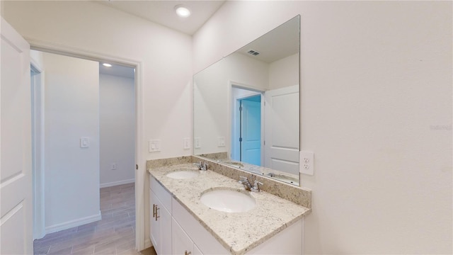 bathroom with vanity and hardwood / wood-style flooring