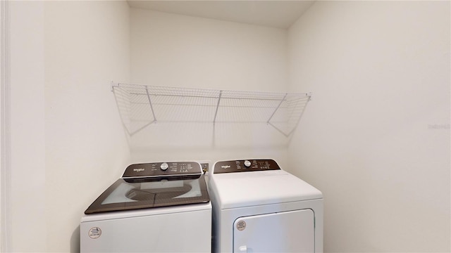 clothes washing area with independent washer and dryer