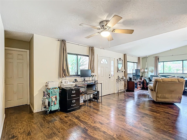 living room with vaulted ceiling, ceiling fan, dark hardwood / wood-style floors, and a textured ceiling