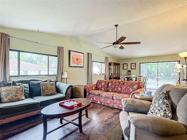 living room featuring ceiling fan, dark wood-type flooring, a textured ceiling, and vaulted ceiling