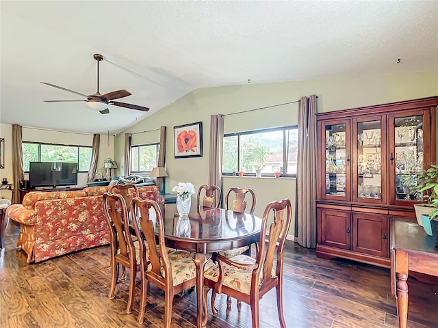 dining room featuring a textured ceiling, ceiling fan, lofted ceiling, and dark wood-type flooring