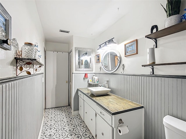 bathroom with tile patterned floors, vanity, and toilet