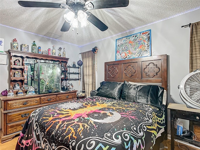 bedroom with a textured ceiling and ceiling fan