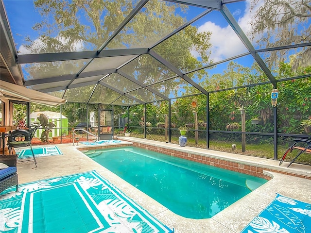 view of swimming pool with glass enclosure and a patio area