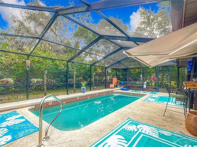 view of swimming pool featuring a patio and a lanai