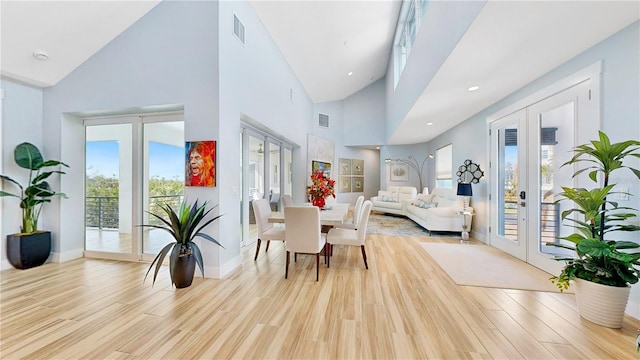 interior space with light wood-type flooring, baseboards, visible vents, and french doors