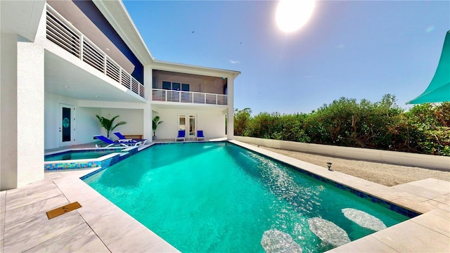 view of pool featuring a patio, french doors, and a pool with connected hot tub