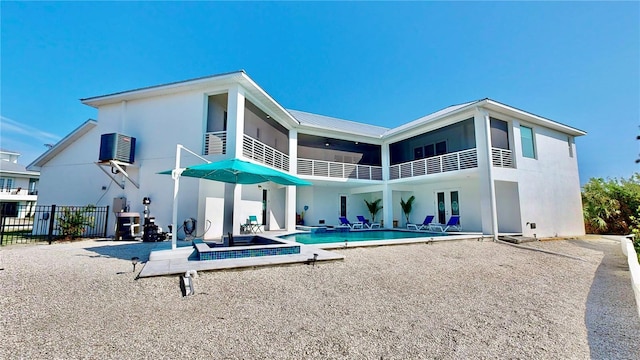 10101 Eagle Preserve Dr, Englewood, FL 34224 - rear view of house featuring a balcony, a patio area, stucco siding, and a metal roof