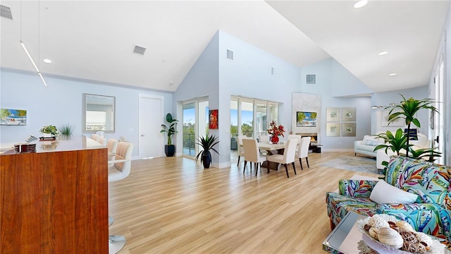 10101 Eagle Preserve Dr, Englewood, FL 34224 - living room with high vaulted ceiling, light wood-style flooring, and recessed lighting