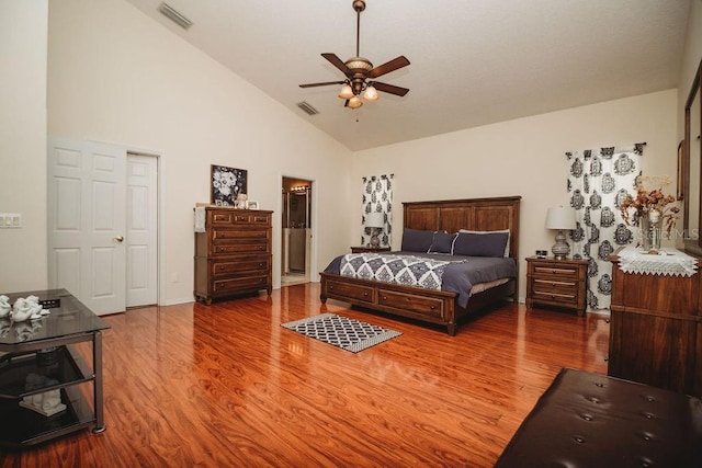 bedroom with ceiling fan, high vaulted ceiling, and hardwood / wood-style flooring