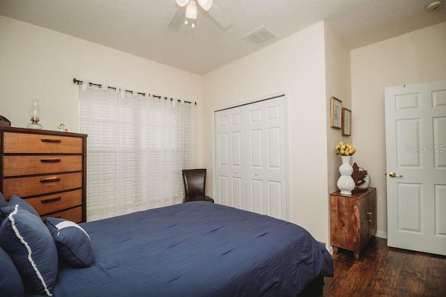 bedroom featuring ceiling fan, dark wood-type flooring, and a closet