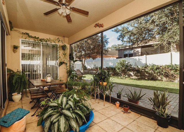 sunroom featuring ceiling fan and plenty of natural light