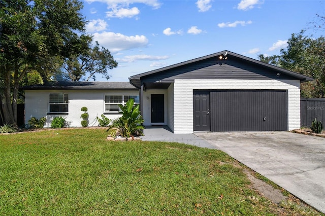 single story home featuring a garage and a front lawn