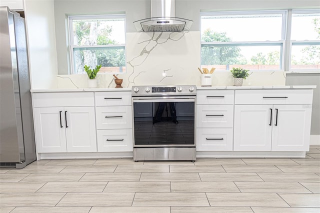 kitchen with stainless steel appliances, white cabinetry, and island range hood