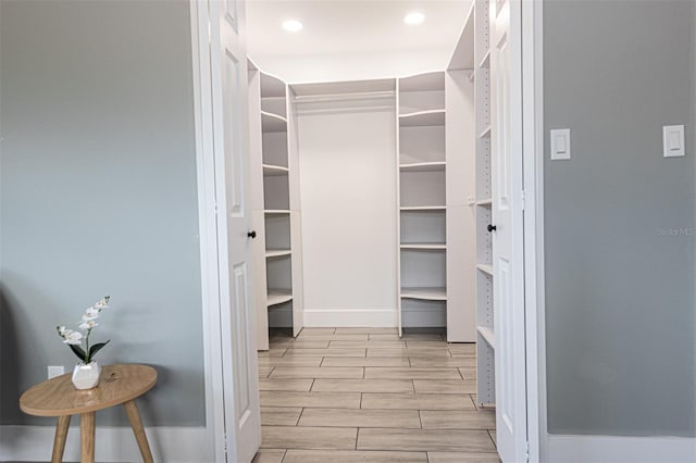 spacious closet with light hardwood / wood-style floors