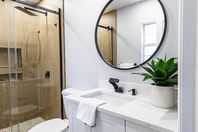 bathroom featuring vanity, toilet, and an enclosed shower