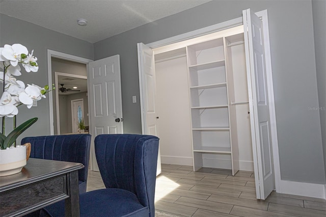 office area with ceiling fan, light hardwood / wood-style floors, and a textured ceiling