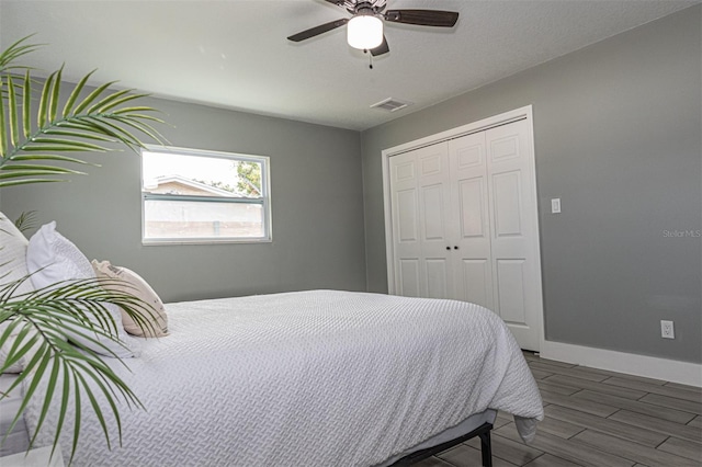 bedroom featuring ceiling fan, a closet, and dark hardwood / wood-style floors