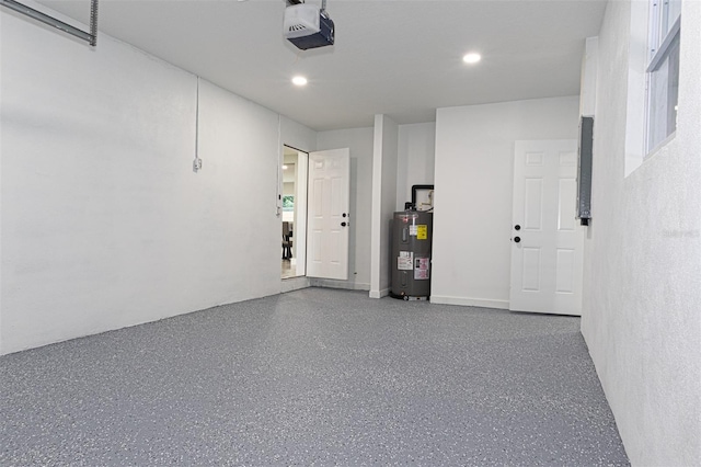 garage with water heater and a garage door opener