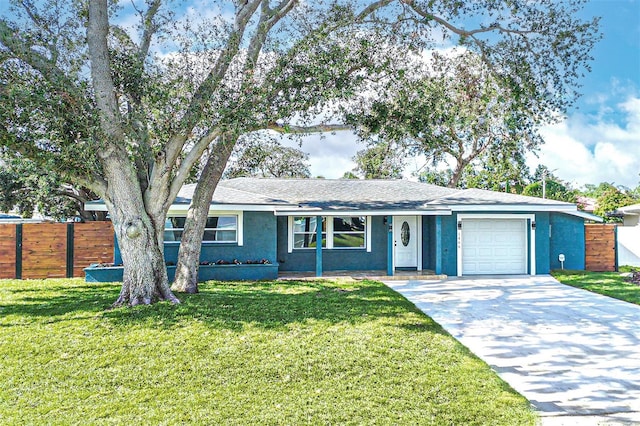 ranch-style home with a front lawn and a garage