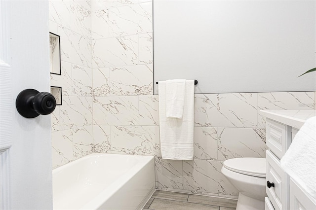 bathroom featuring tile walls and toilet