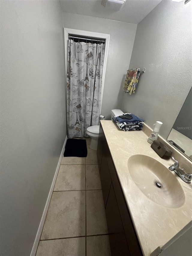 bathroom with tile patterned flooring, vanity, a shower with shower curtain, and toilet