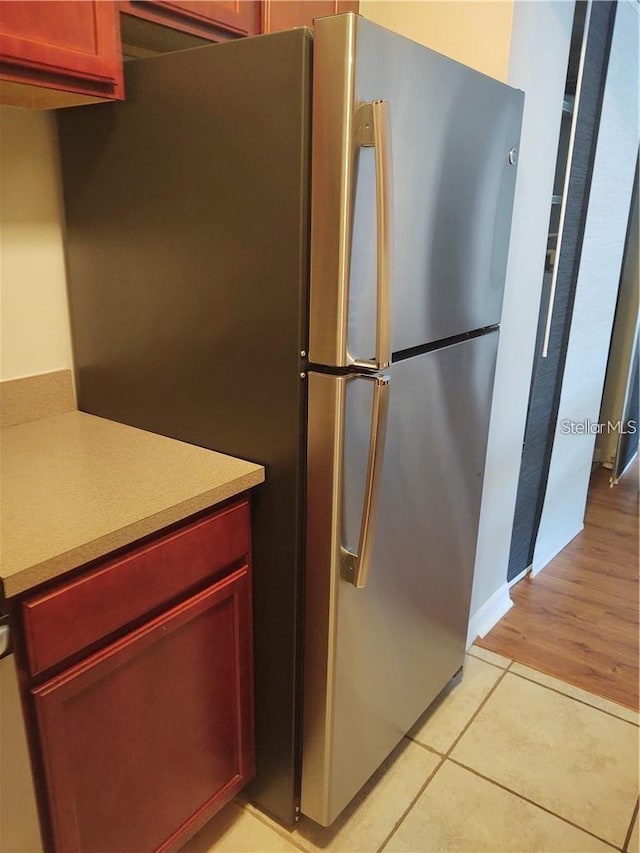 kitchen with light hardwood / wood-style floors and stainless steel refrigerator