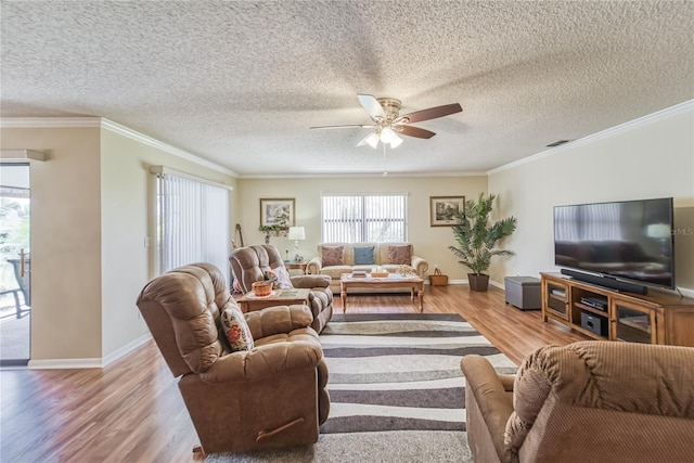 living room with a textured ceiling, light wood-type flooring, and ornamental molding