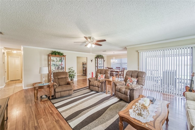 living room with ceiling fan, a textured ceiling, and light hardwood / wood-style flooring