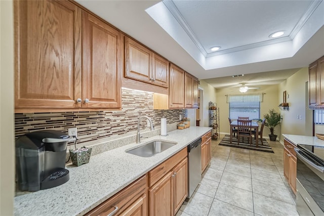 kitchen featuring backsplash, sink, ornamental molding, appliances with stainless steel finishes, and light stone counters