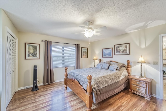 bedroom featuring ceiling fan, a closet, a textured ceiling, and hardwood / wood-style flooring