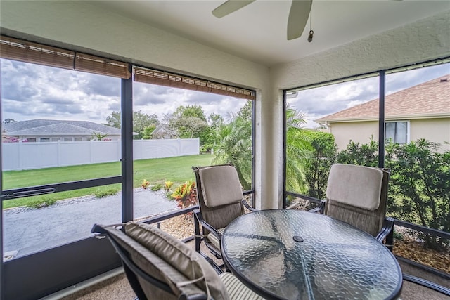 sunroom with a wealth of natural light and ceiling fan