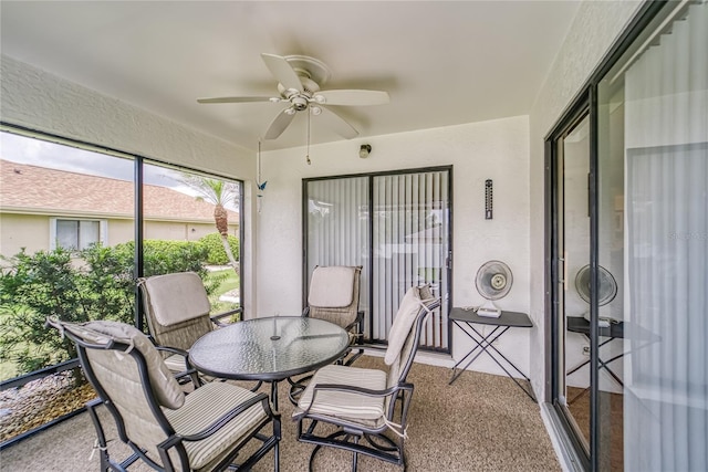 sunroom / solarium featuring ceiling fan