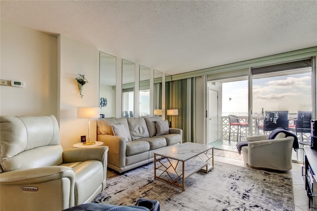 tiled living room featuring a textured ceiling