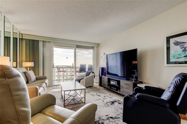 living room featuring a textured ceiling and floor to ceiling windows