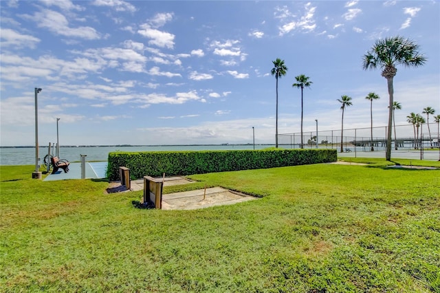 view of community featuring a yard and a water view