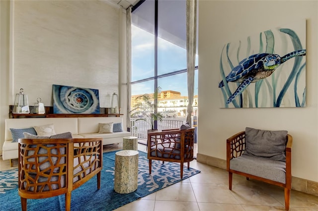 sitting room featuring expansive windows and light tile patterned floors