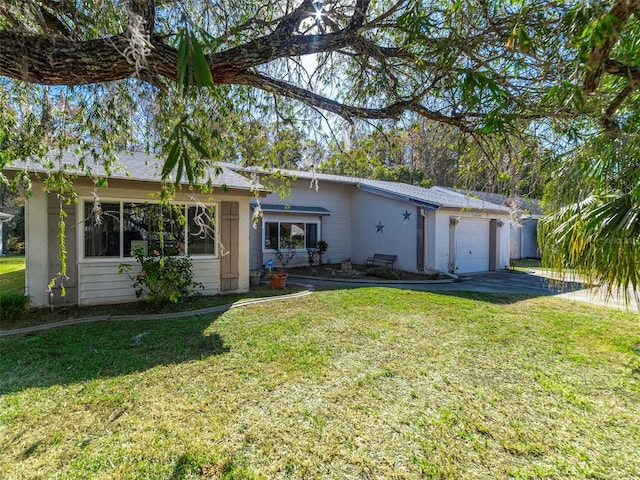 back of property with a lawn and a garage