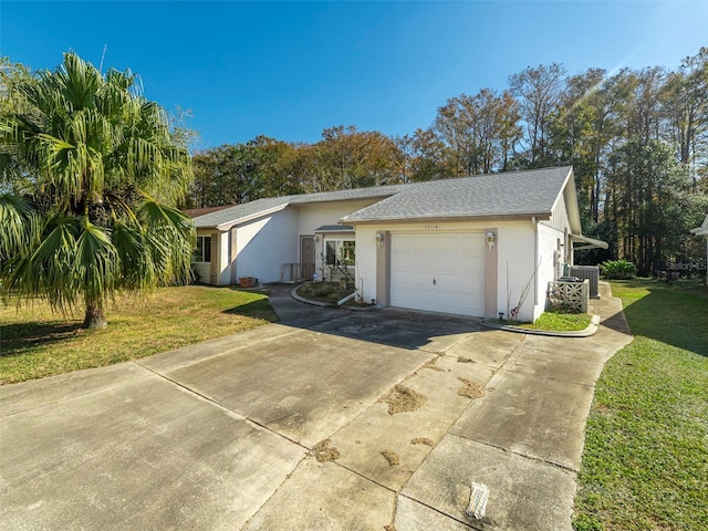 view of side of property with a garage and a lawn