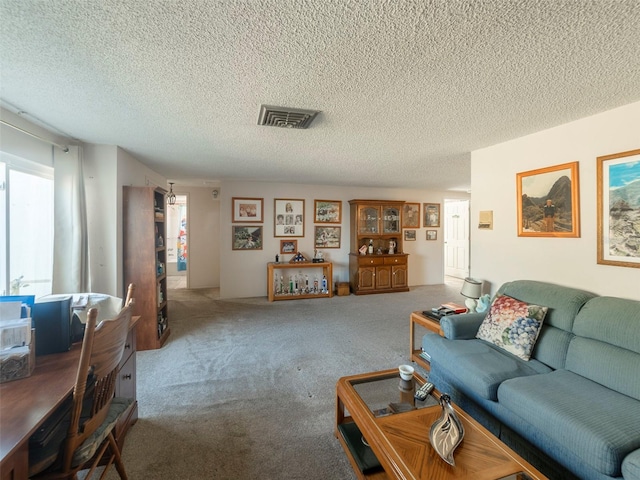 living room with carpet flooring, plenty of natural light, and a textured ceiling