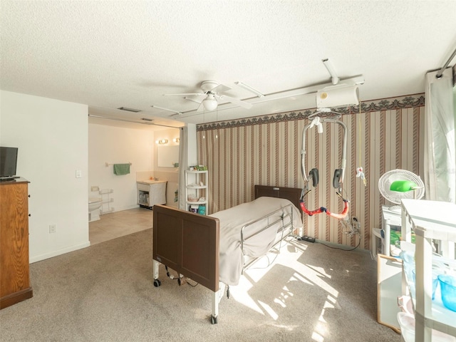 bedroom featuring a textured ceiling and light carpet