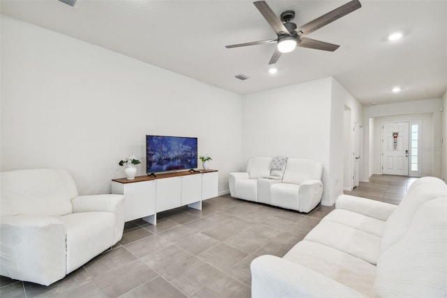 living room with tile patterned flooring and ceiling fan