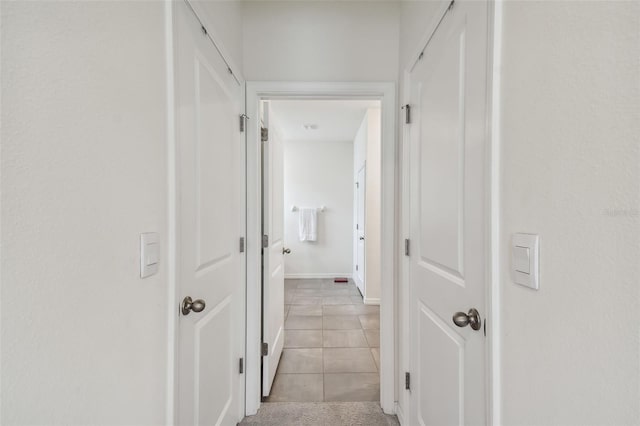 hallway featuring light tile patterned flooring