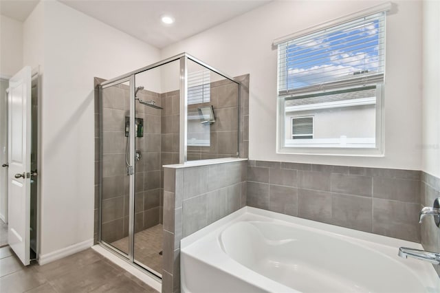 bathroom with tile patterned floors and independent shower and bath