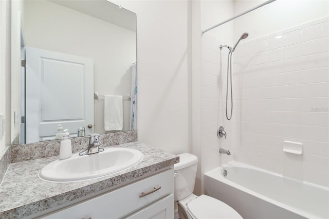 full bathroom with toilet, vanity, and tiled shower / bath combo