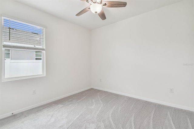 spare room featuring carpet flooring and ceiling fan