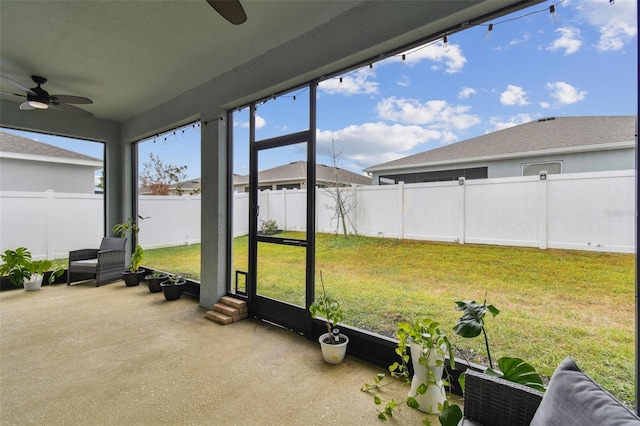 sunroom featuring ceiling fan