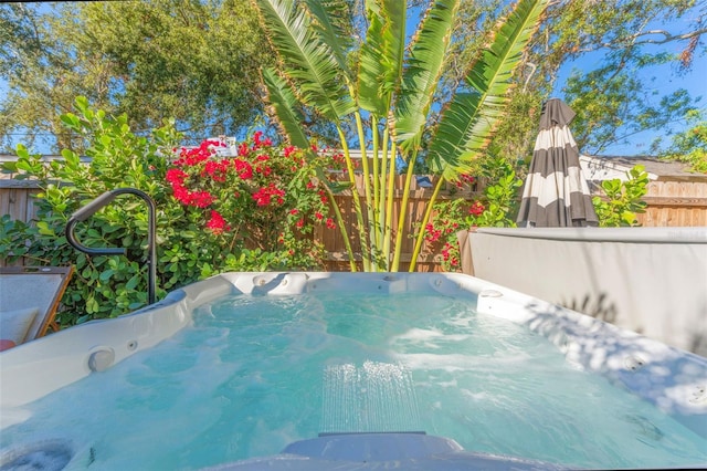 view of pool with a hot tub