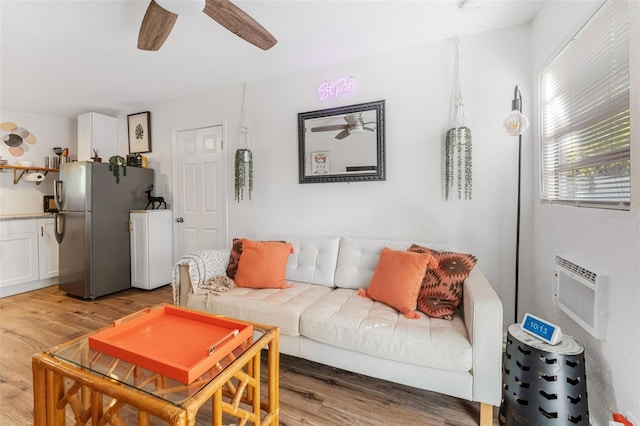 living room featuring a wall mounted AC, ceiling fan, light hardwood / wood-style flooring, and billiards